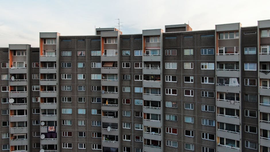 A detailed view of an urban apartment building facade in Berlin, showcasing multiple balconies.