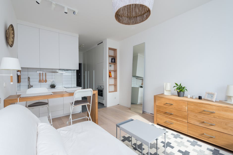 Bright and stylish open-plan apartment interior featuring modern furniture and decor.